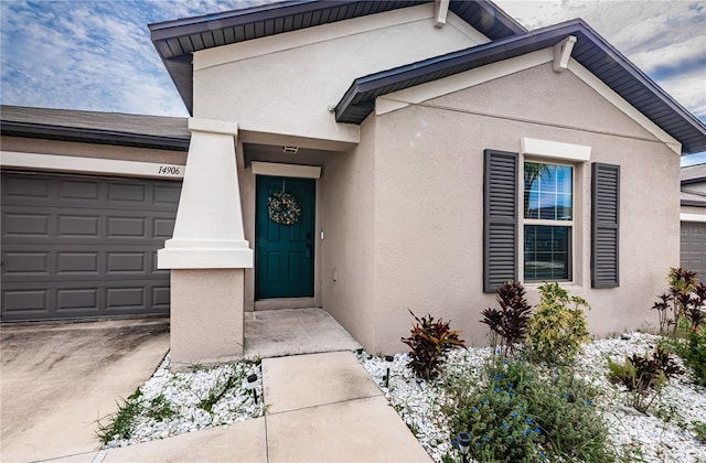 doorway to property with a garage