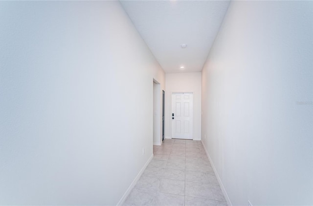 hallway with light tile patterned flooring, recessed lighting, and baseboards