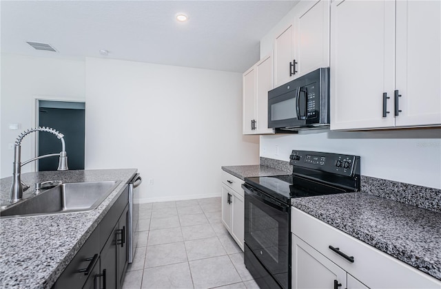 kitchen with visible vents, black appliances, white cabinets, and a sink