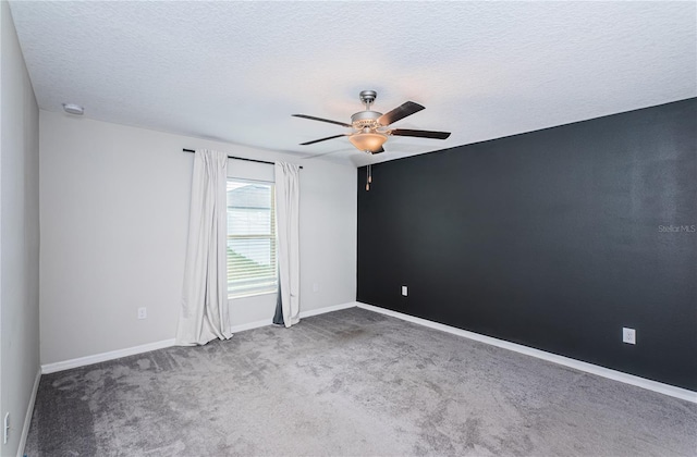 carpeted empty room featuring a textured ceiling and ceiling fan