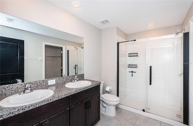 full bath featuring a stall shower, a sink, tile patterned floors, and visible vents