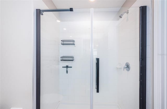 bathroom with a shower with door