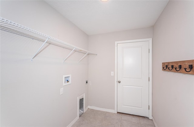laundry room featuring laundry area, light tile patterned floors, hookup for an electric dryer, washer hookup, and baseboards