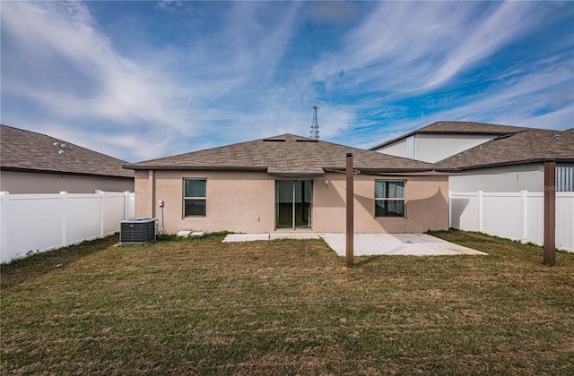 rear view of property with a patio, a fenced backyard, stucco siding, and a lawn