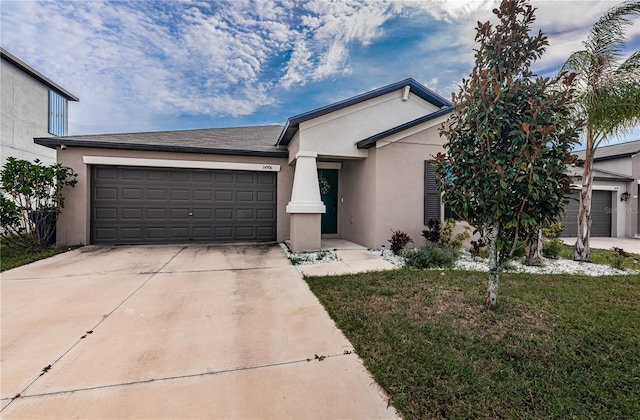 ranch-style house with a front yard, stucco siding, driveway, and an attached garage