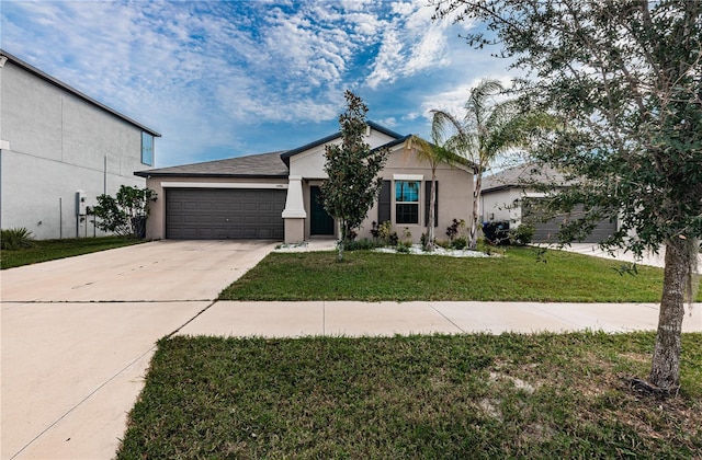 view of front facade featuring driveway, a front yard, stucco siding, and a garage