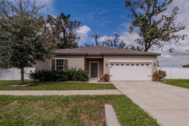 single story home with a front yard and a garage