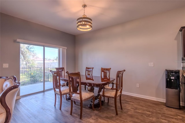 dining area with a notable chandelier and dark hardwood / wood-style floors