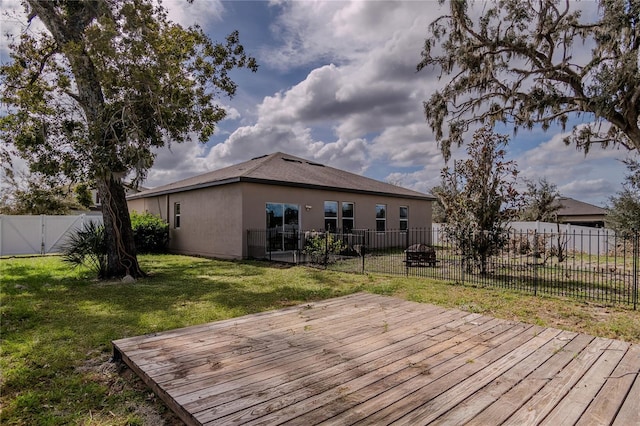 wooden deck featuring a lawn