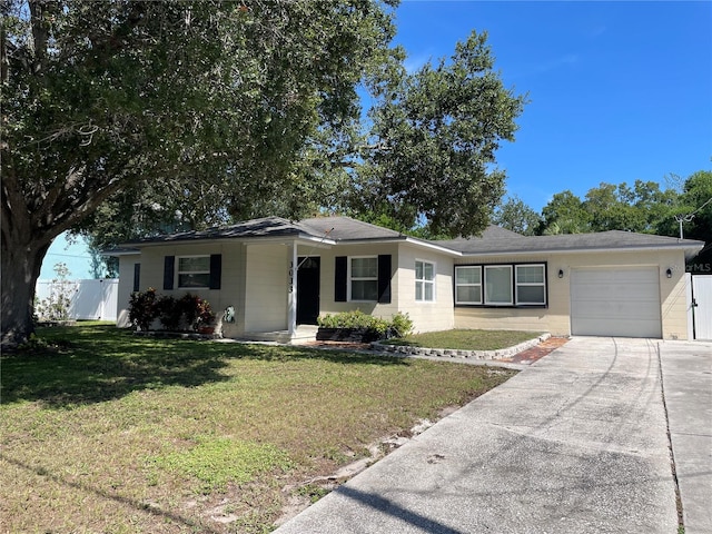 single story home featuring a front yard and a garage