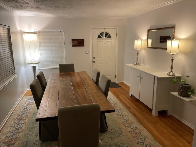 dining space featuring a textured ceiling, dark hardwood / wood-style floors, and crown molding