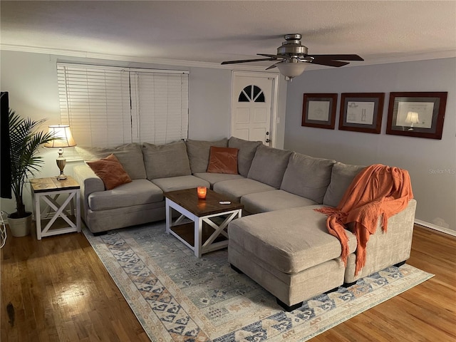 living room featuring crown molding, ceiling fan, a textured ceiling, and hardwood / wood-style flooring