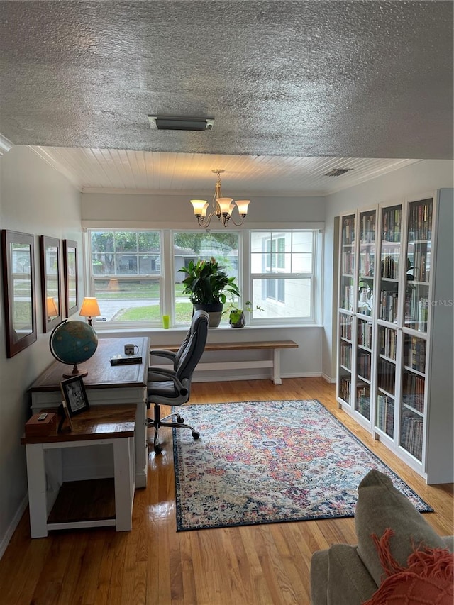 home office featuring hardwood / wood-style floors, a textured ceiling, and an inviting chandelier