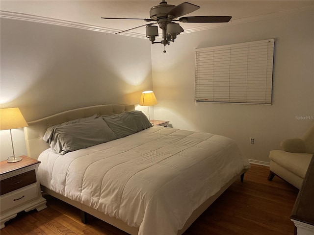 bedroom with ceiling fan, ornamental molding, and dark wood-type flooring