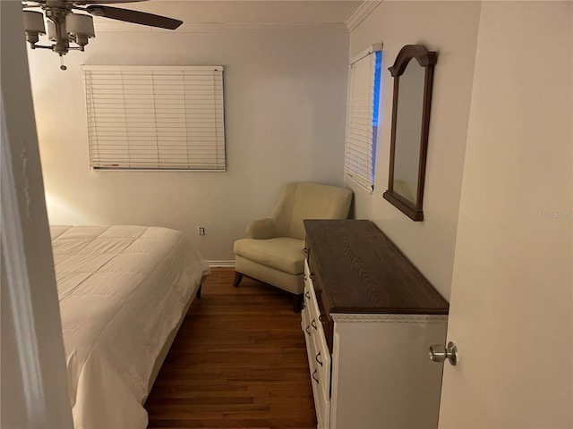 bedroom featuring ceiling fan, dark wood-type flooring, and ornamental molding