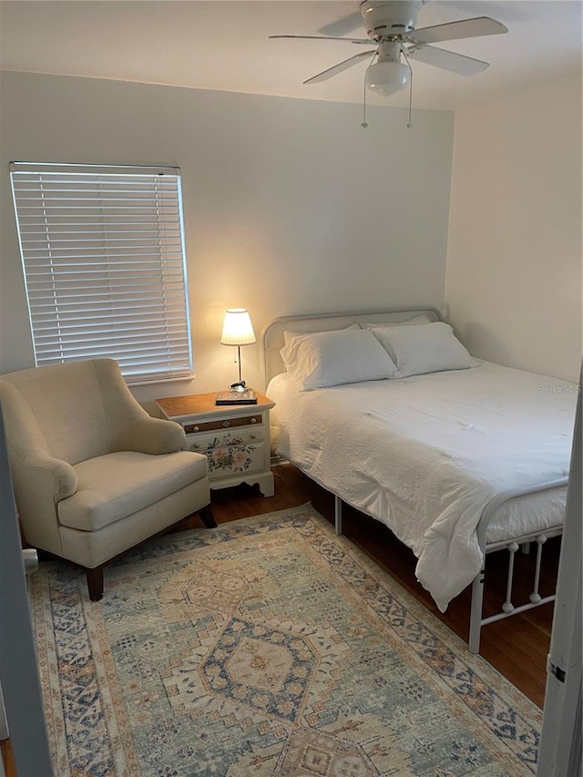 bedroom with ceiling fan and hardwood / wood-style floors