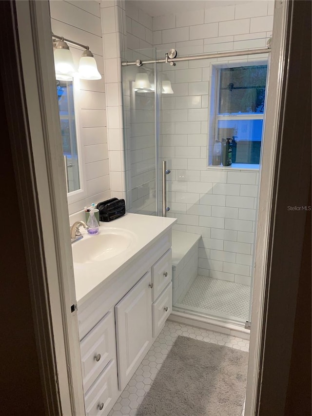 bathroom featuring tile patterned floors, vanity, and a shower with door