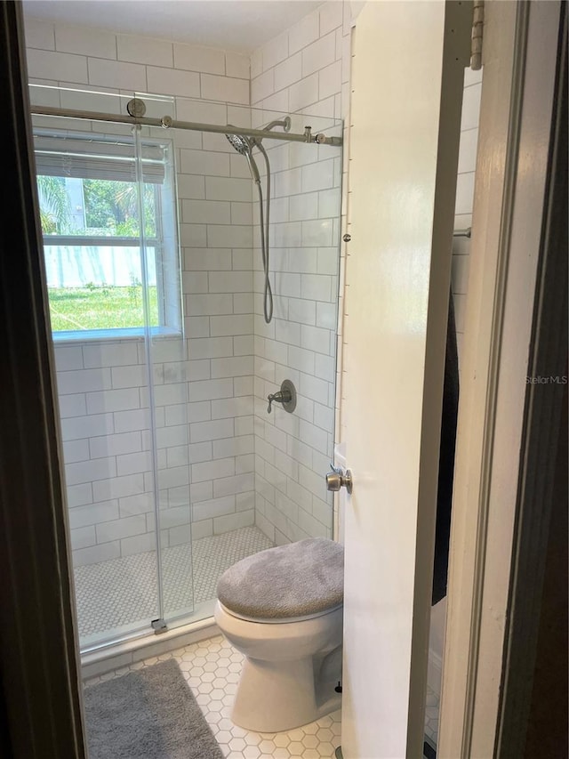 bathroom with tile patterned floors and walk in shower