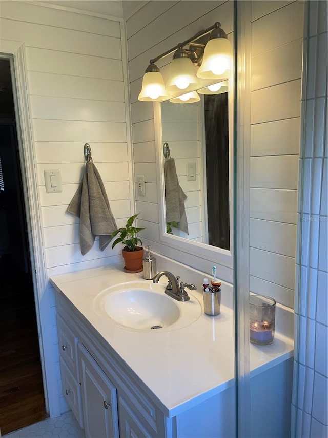 bathroom with vanity and wooden walls