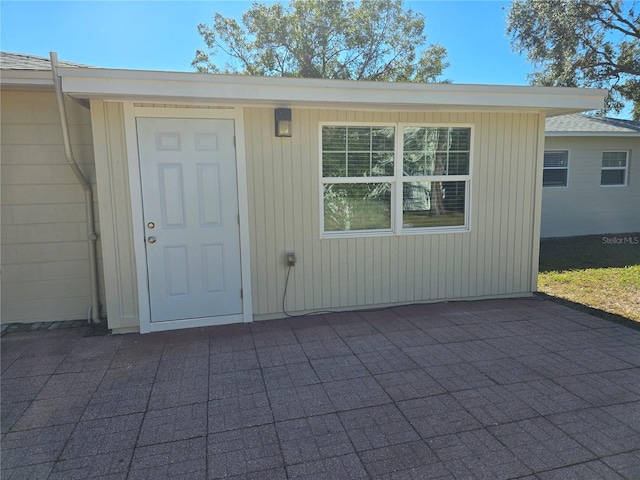 view of exterior entry featuring a patio