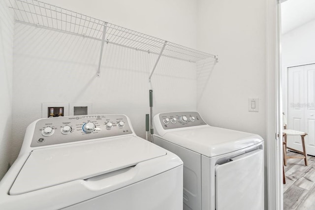 laundry room featuring hardwood / wood-style flooring and washer and clothes dryer