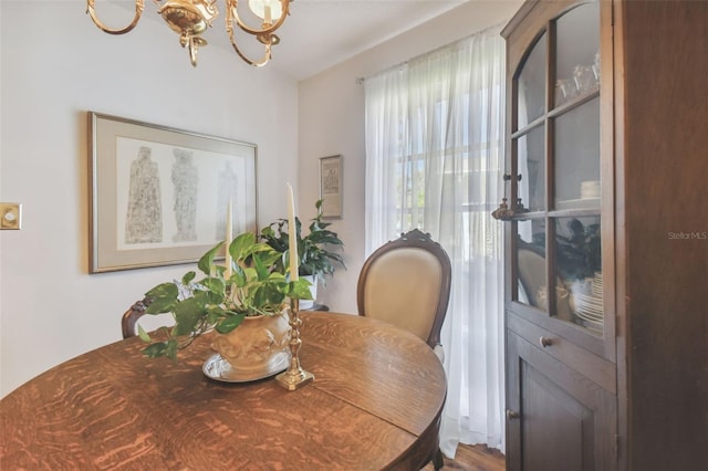 dining room with a notable chandelier and hardwood / wood-style floors