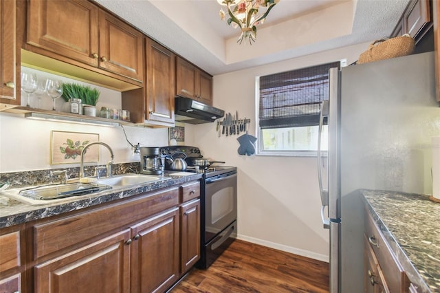 kitchen with black range with electric cooktop, sink, a raised ceiling, dark hardwood / wood-style flooring, and stainless steel fridge