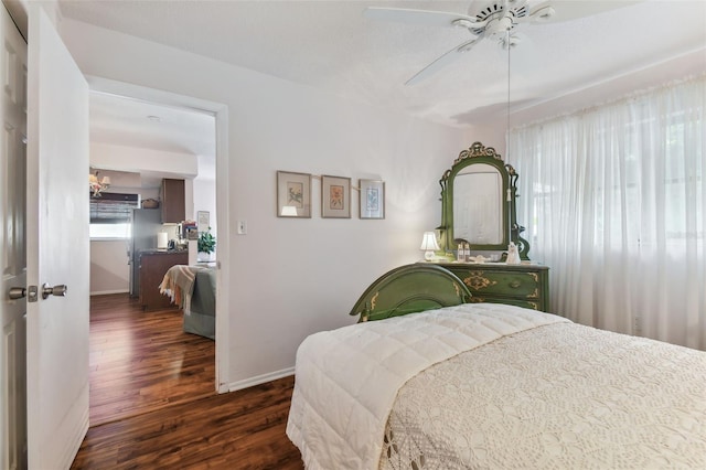 bedroom with ceiling fan and dark hardwood / wood-style flooring