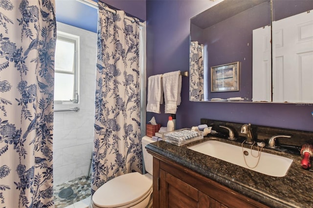 bathroom featuring toilet, walk in shower, and vanity