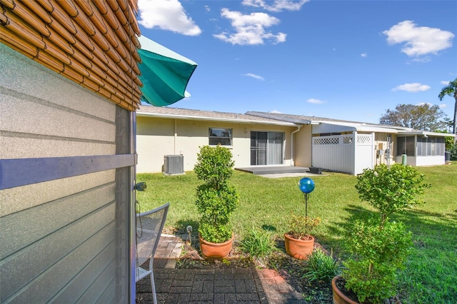 exterior space with a sunroom and central AC unit