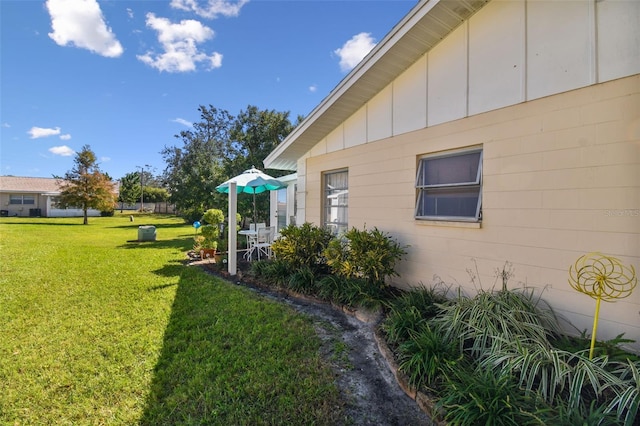 view of side of property featuring a yard