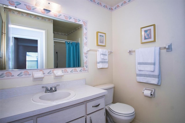 bathroom featuring vanity and toilet