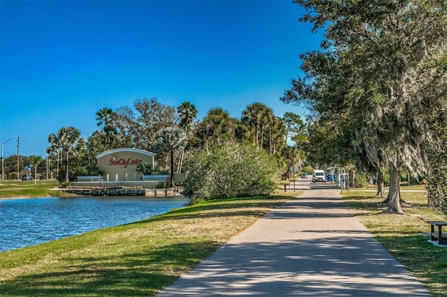 view of home's community featuring a lawn and a water view