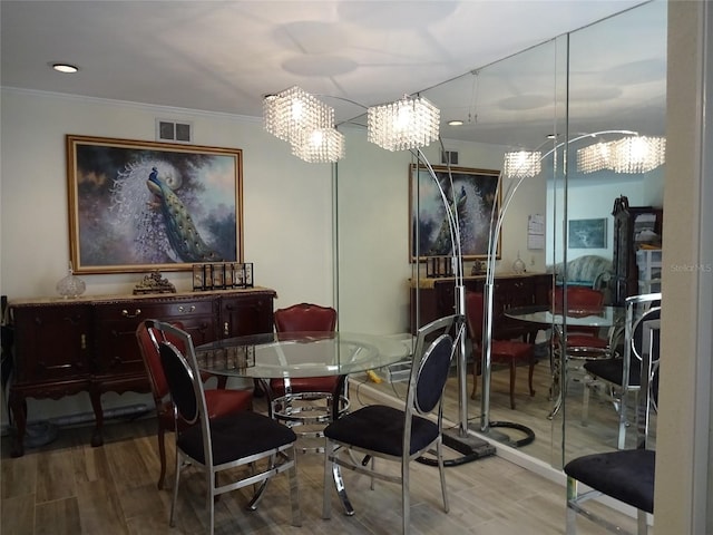 dining space featuring ornamental molding and wood-type flooring