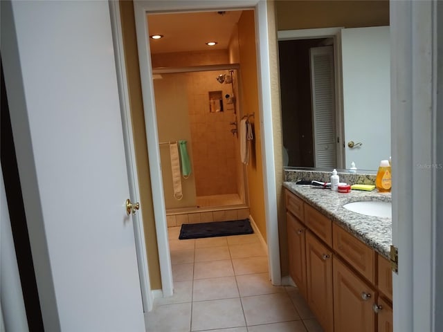 bathroom with vanity, tile patterned floors, and a shower with door