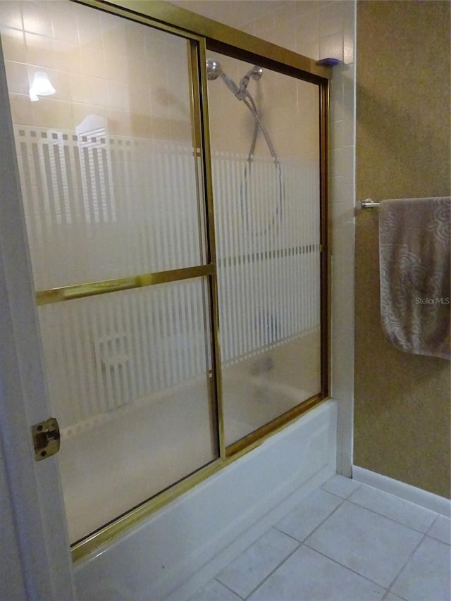 bathroom featuring enclosed tub / shower combo and tile patterned flooring