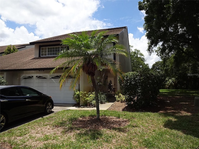 13936 Clubhouse Cir Unit 13936, Tampa, FL 33618 - view of front of home with concrete driveway, roof with shingles, and stucco siding
