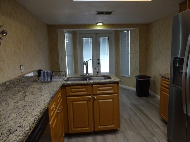 13936 Clubhouse Cir Unit 13936, Tampa, FL 33618 - kitchen with wallpapered walls, visible vents, french doors, a sink, and appliances with stainless steel finishes