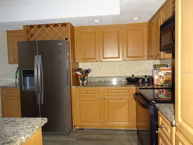 kitchen featuring black appliances, dark wood-type flooring, stone countertops, and backsplash