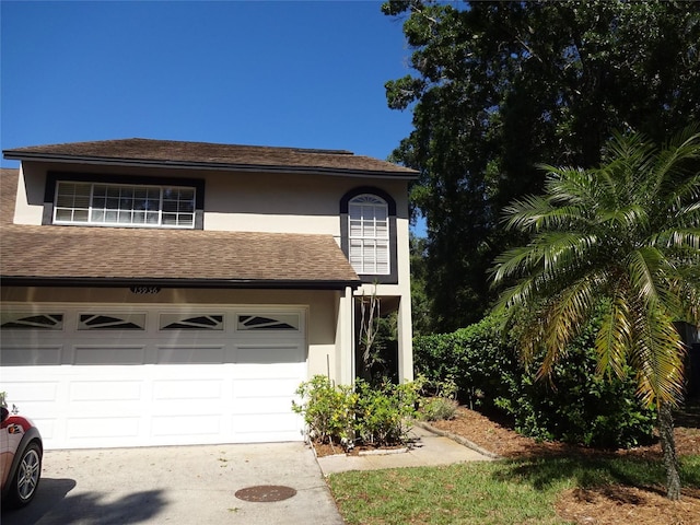 13936 Clubhouse Cir Unit 13936, Tampa, FL 33618 - exterior space featuring stucco siding, driveway, roof with shingles, and a garage