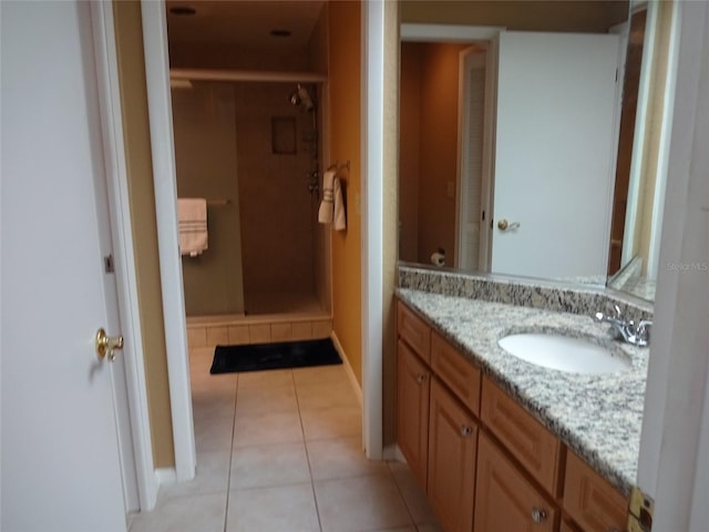 bathroom featuring vanity, tile patterned flooring, and a shower with door