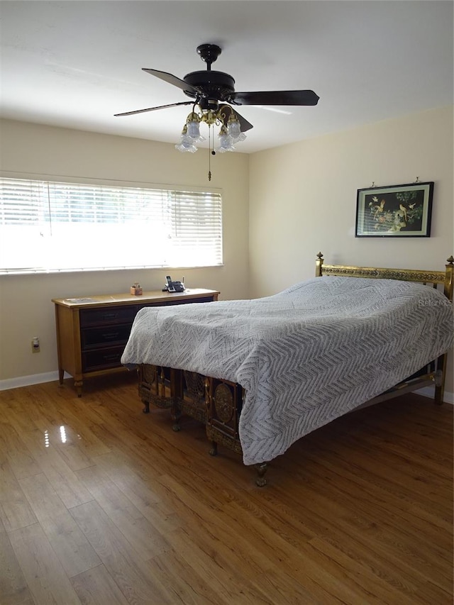 bedroom with wood-type flooring and ceiling fan