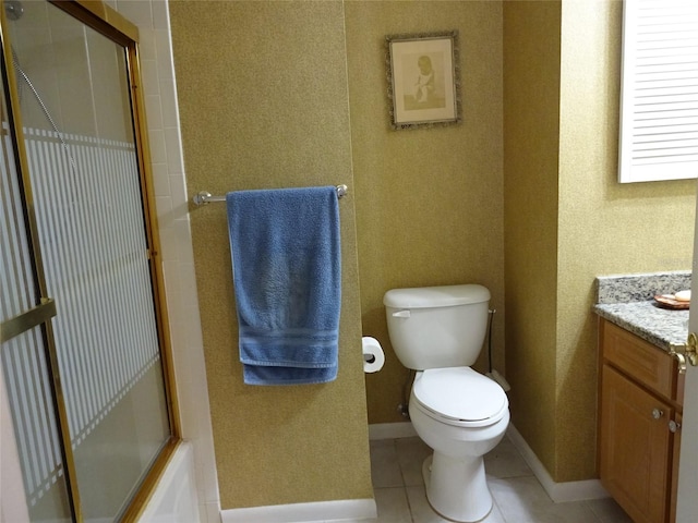 full bathroom featuring vanity, bath / shower combo with glass door, toilet, and tile patterned flooring