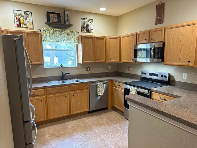 kitchen featuring sink, appliances with stainless steel finishes, and light tile patterned flooring