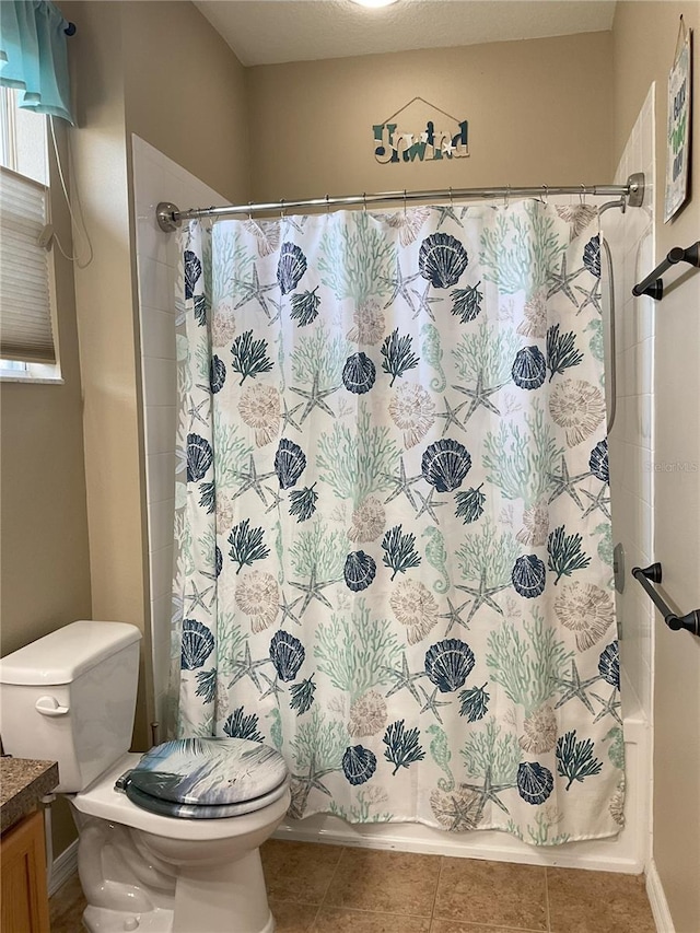 full bathroom with vanity, toilet, tile patterned floors, and shower / tub combo with curtain