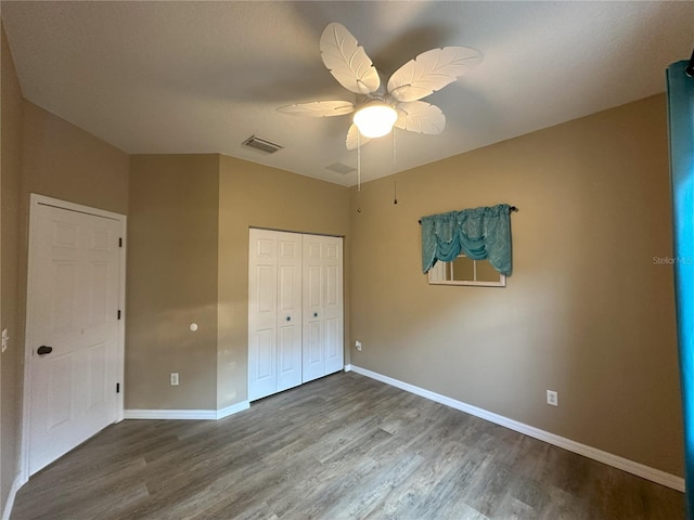 unfurnished bedroom with a closet, hardwood / wood-style floors, and ceiling fan