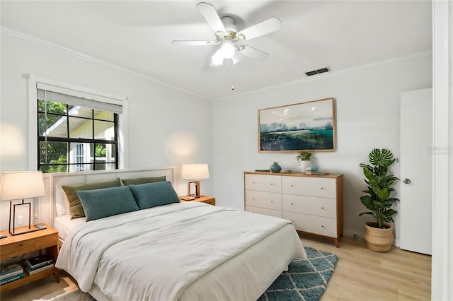 bedroom featuring light hardwood / wood-style flooring, ornamental molding, and ceiling fan