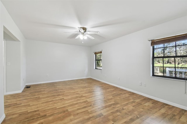 unfurnished room featuring light wood-type flooring and ceiling fan