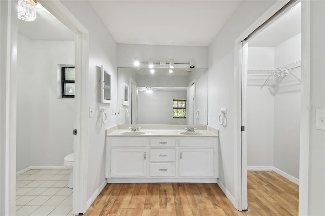 bathroom featuring vanity, toilet, plenty of natural light, and hardwood / wood-style floors