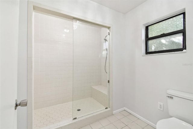 bathroom with toilet, walk in shower, and tile patterned floors